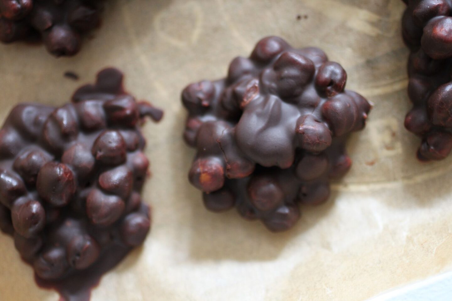 some chocolate chickpeas on a lined baking tray
