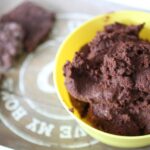 bowl of chocolate hummus on a tray with some crackers