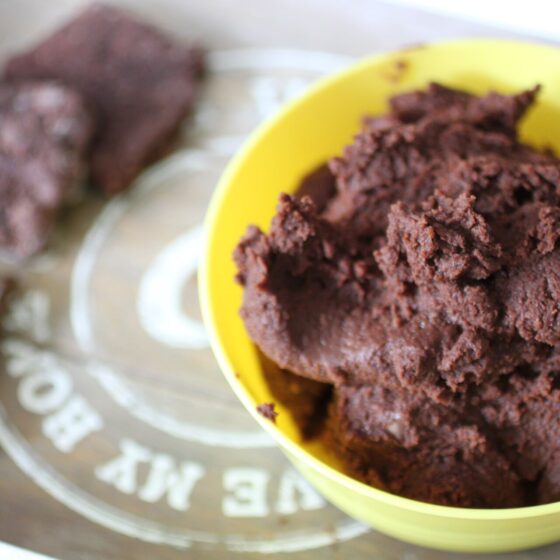 bowl of chocolate hummus on a tray with some crackers
