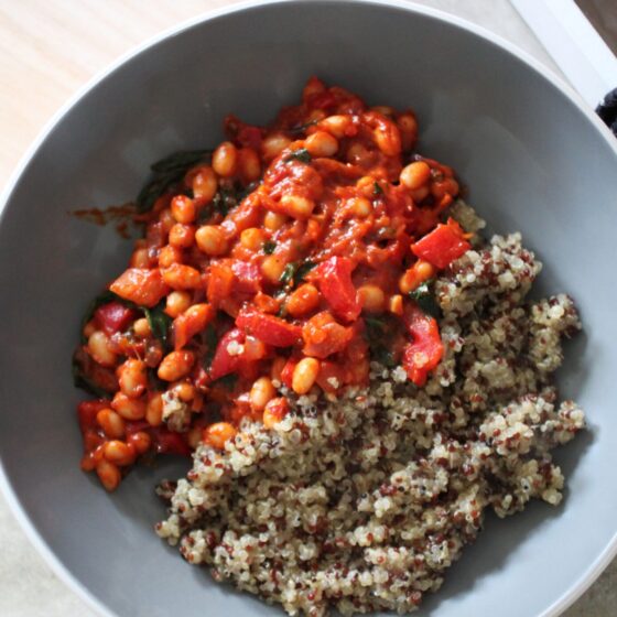 close up shot of a bowl of creamy harissa beans and quinoa