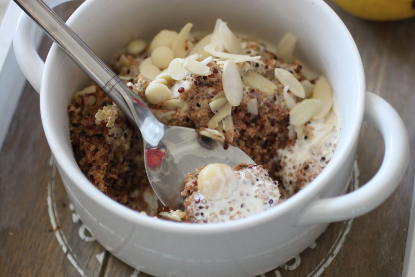 a bowl of lemon breakfast quinoa with a spoon in it