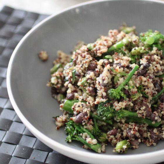 a large bowl filled with a serving of protein grain salad