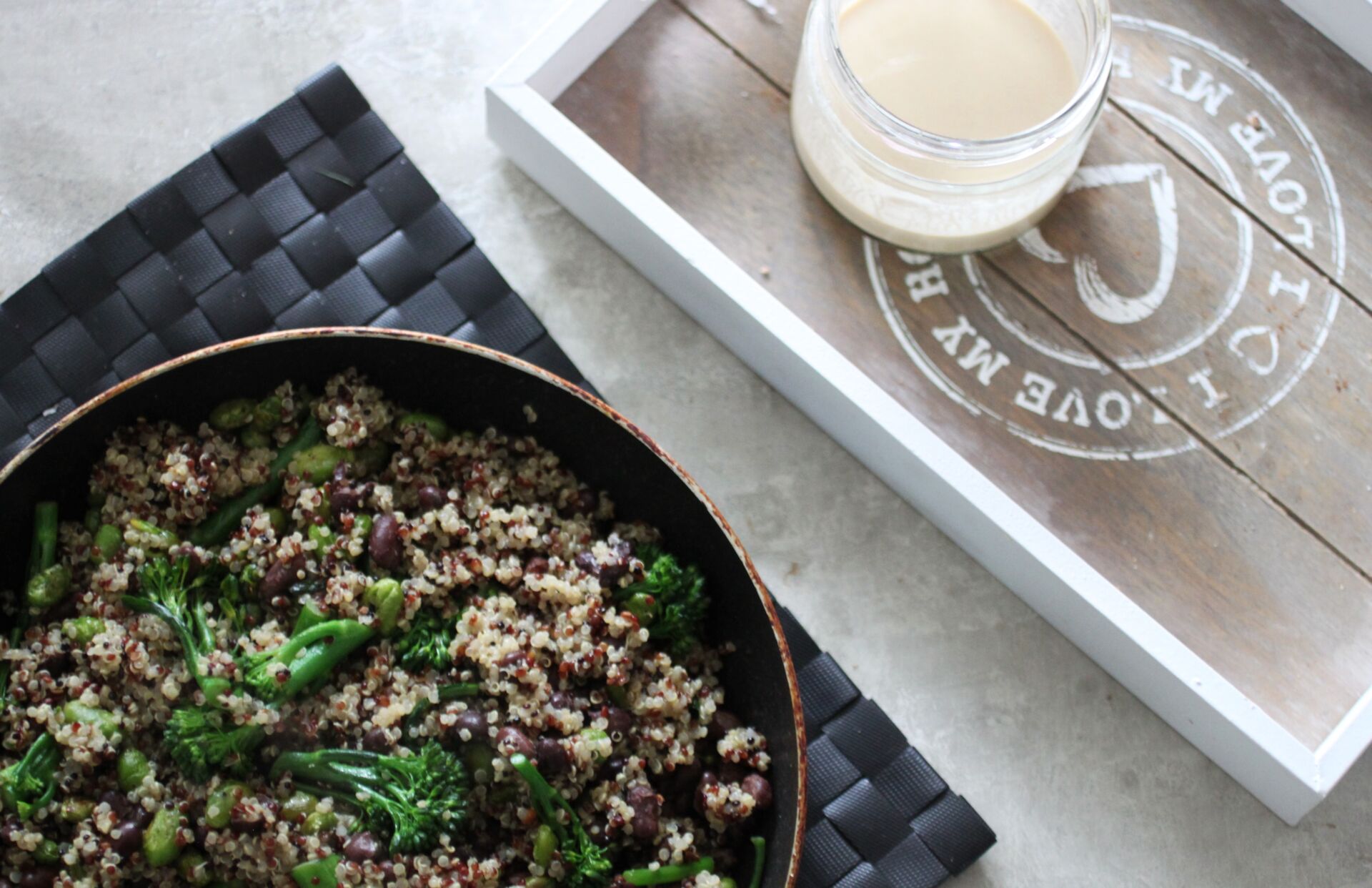 grain salad with a pot of dressing