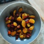 a grey pasta bowl filled with roasted squash gnocchi