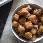 large bowl filled with tandoori tofu bites, half breaded, half just battered