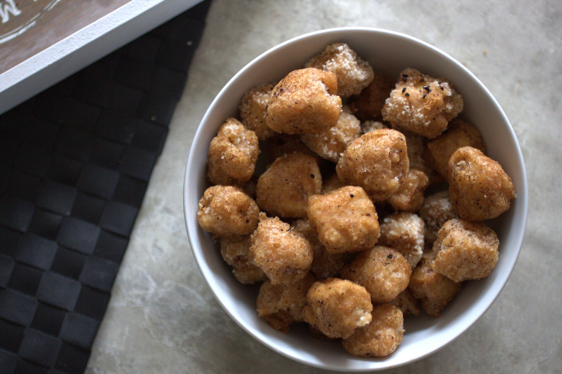 large bowl filled with tandoori tofu bites, half breaded, half just battered