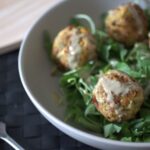 bowl of courgette falafel drizzled with tahini