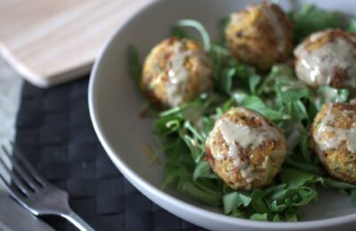 bowl of courgette falafel drizzled with tahini