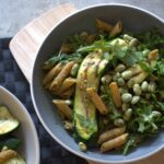 two bowls of grilled greens pasta salad on a dining table