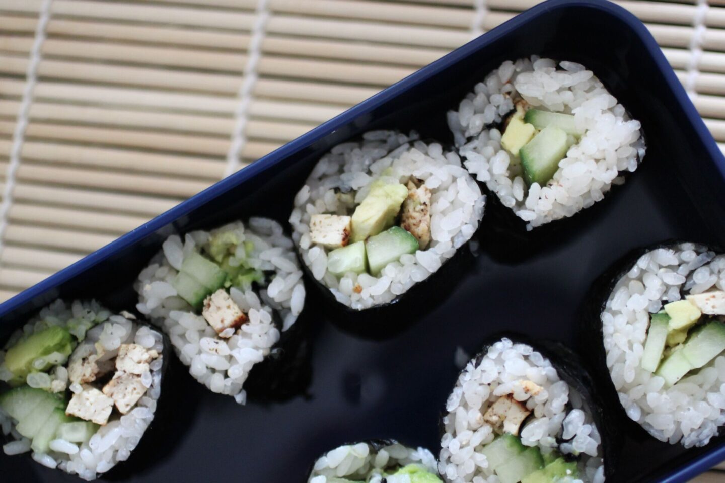 bento box filled with several homemade sushi rolls