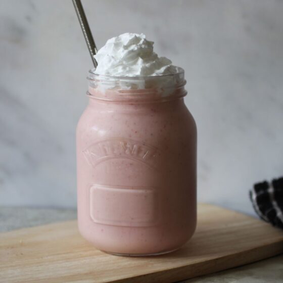strawberry milkshake on a wooden board