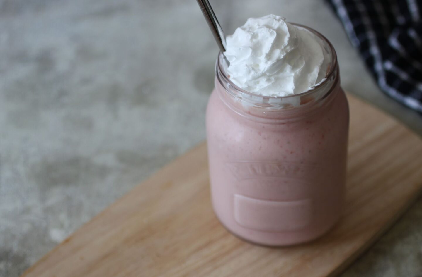 kilner jar filled with strawberry milkshake, shot from above
