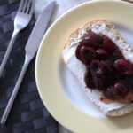 balsamic cherry ciabatta on a white plate with yellow rim, shot from above