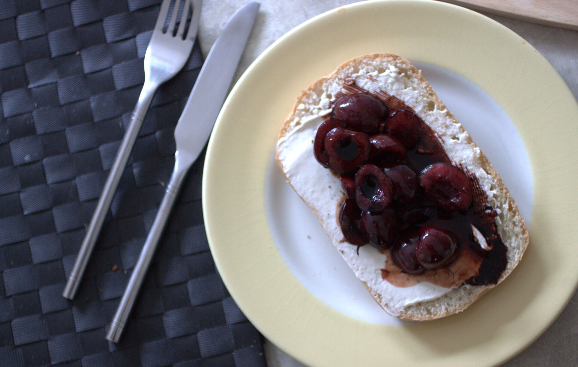balsamic cherry ciabatta on a white plate with yellow rim, shot from above