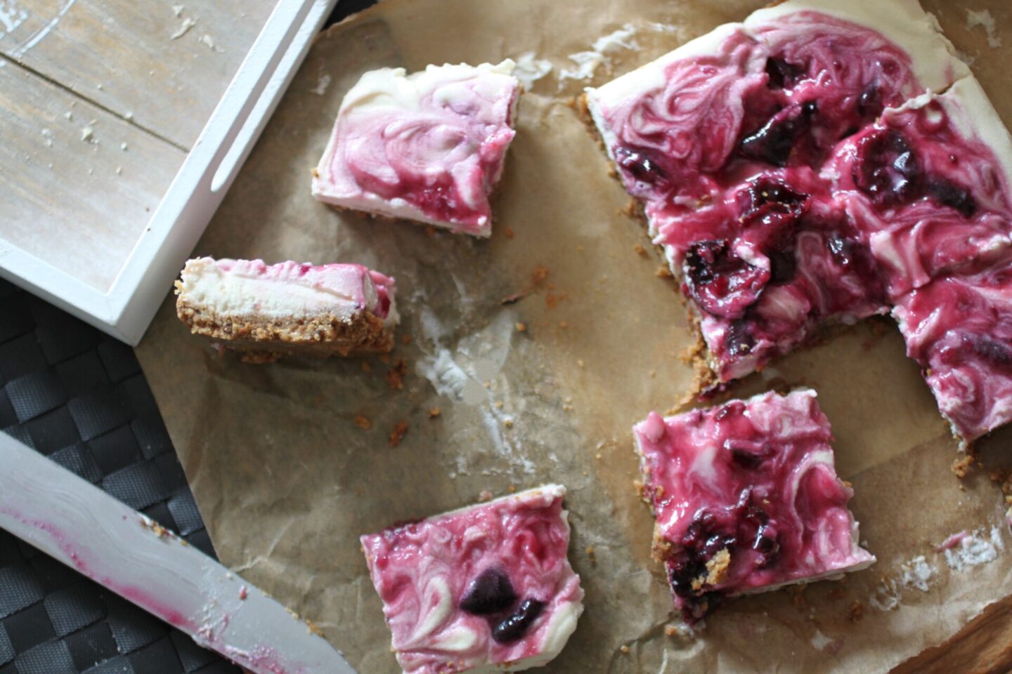 cherry cheesecake on a sheet of greaseproof paper, cut into squares