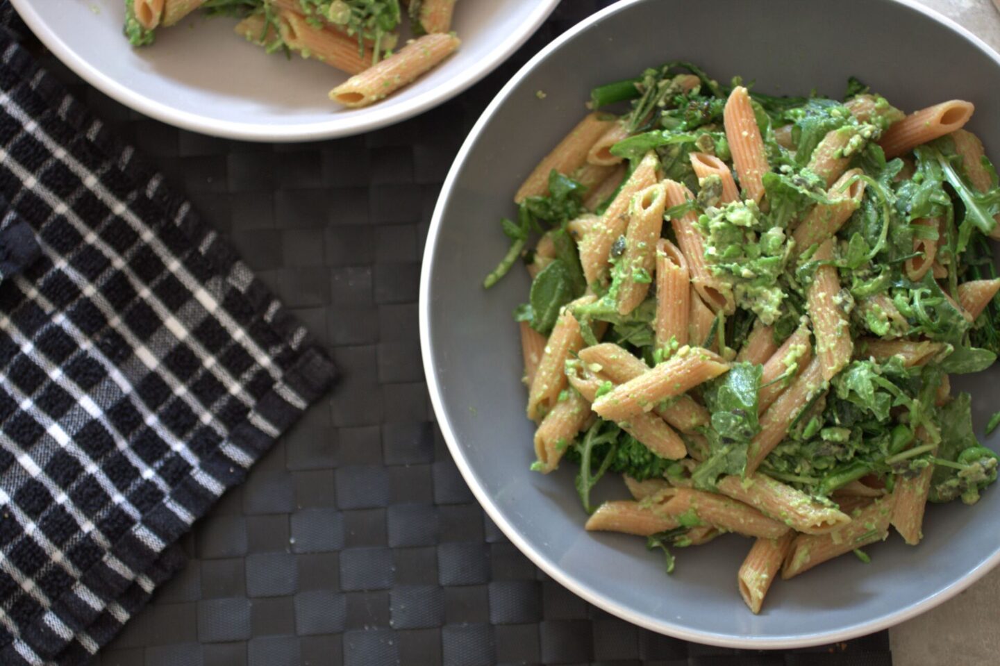 two bowls of pea and rosemary pasta on a table
