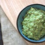 small blue ceramic pot filled with pea and rosemary pesto
