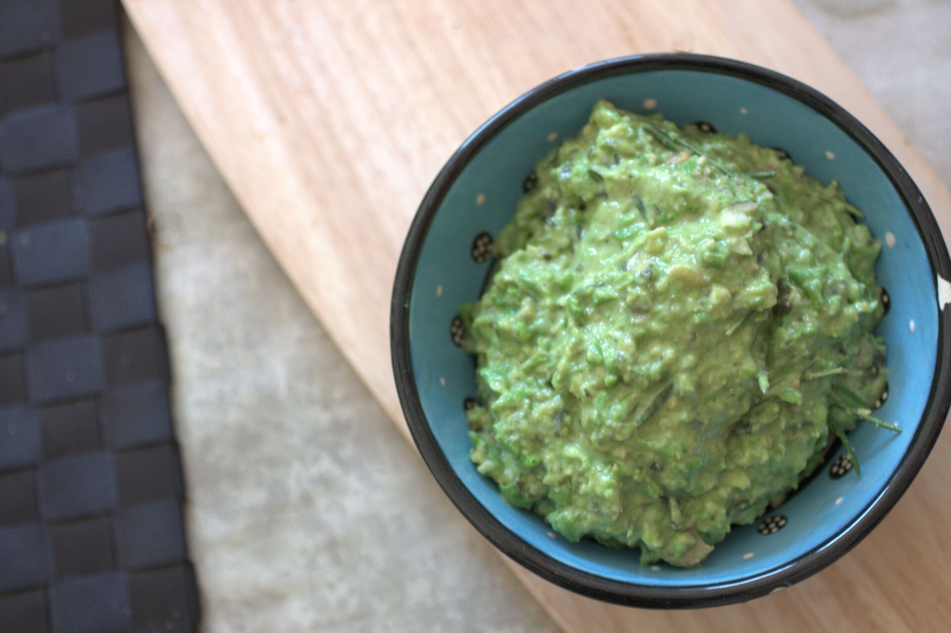 small blue ceramic pot filled with pea and rosemary pesto
