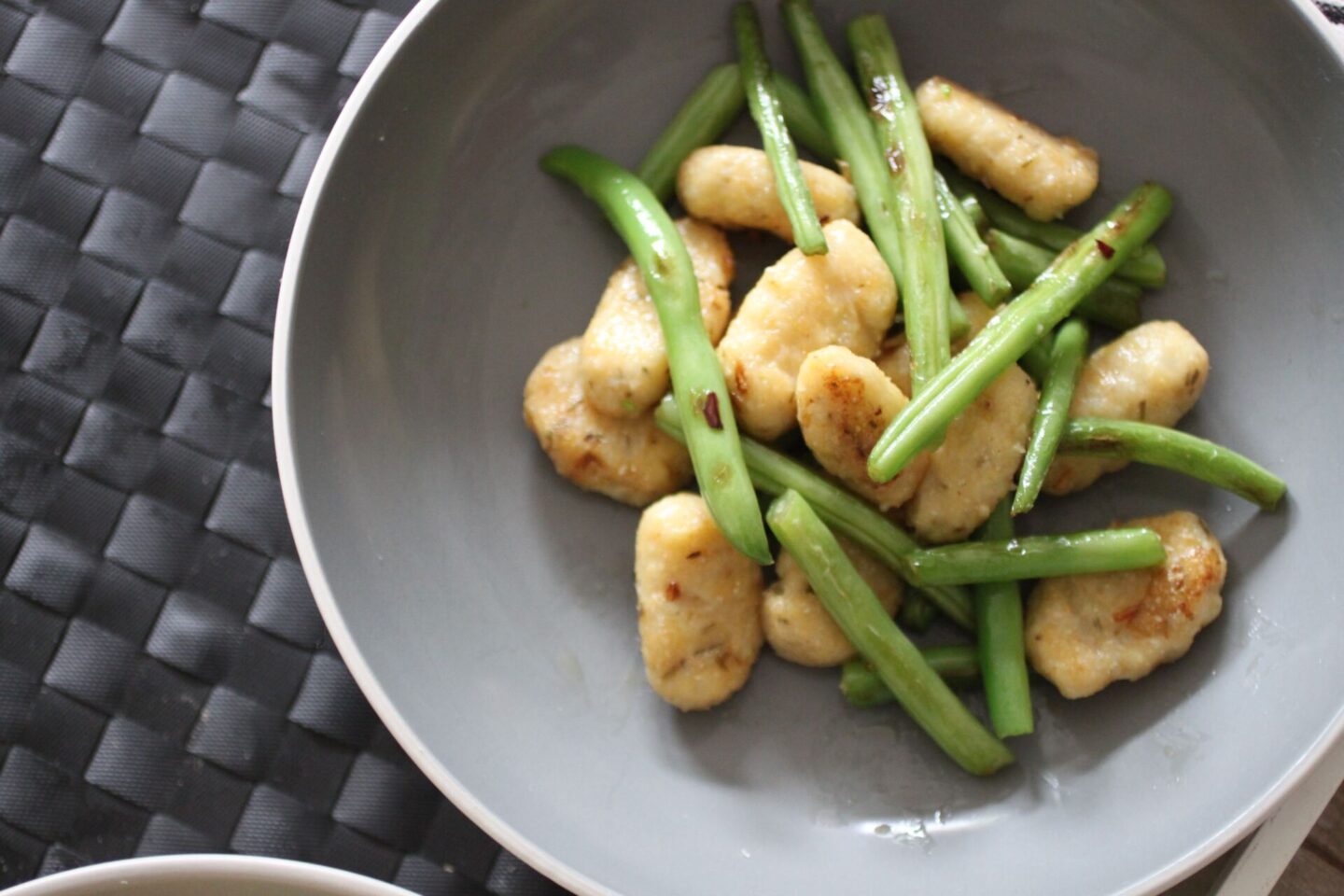 a bowl of gluten free vegan gnocchi with green beans