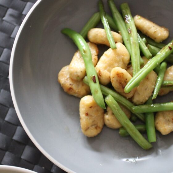 a bowl of gluten free vegan gnocchi with green beans