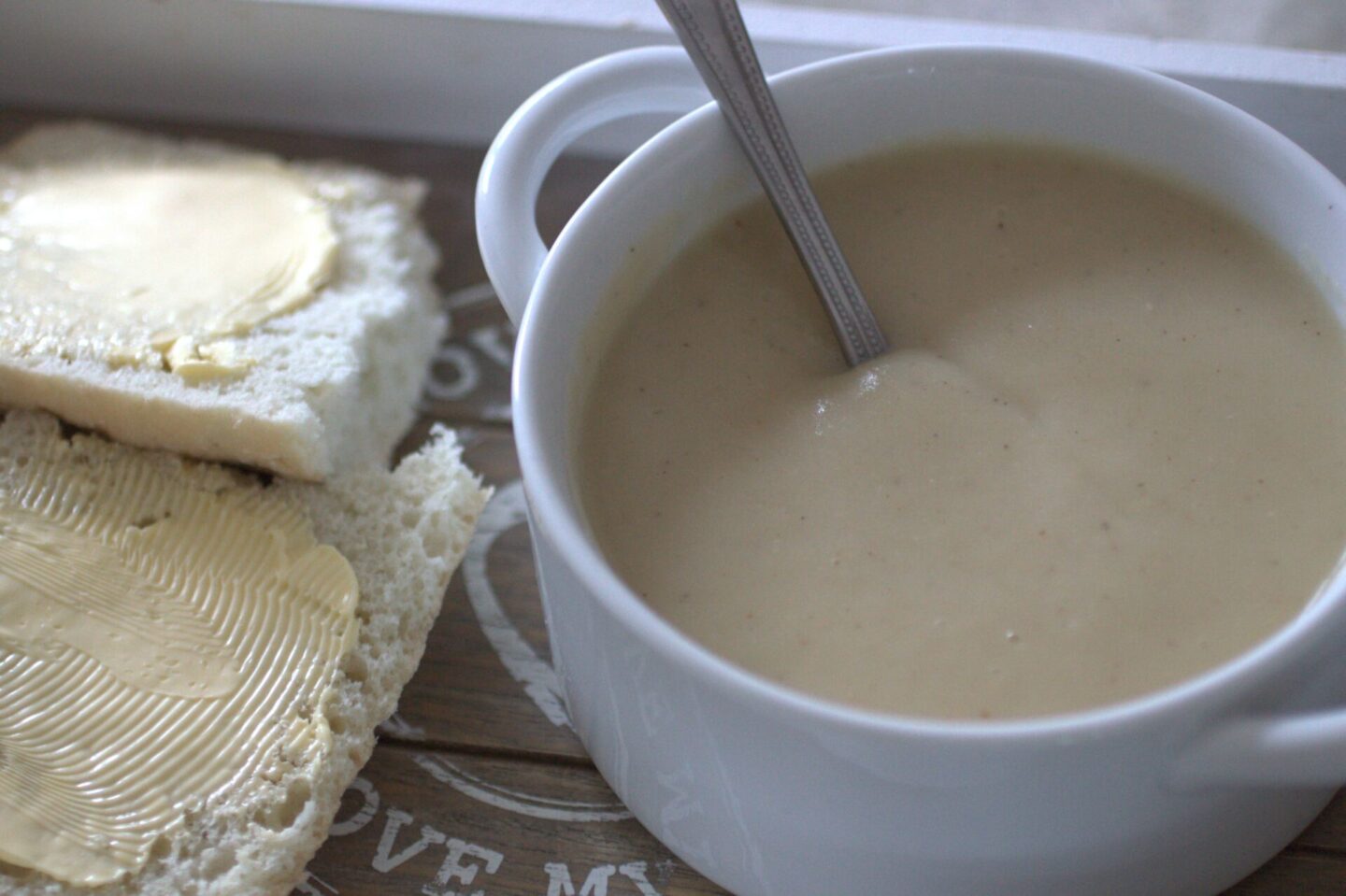 bowl of parsnip truffle soup with a spoon in it