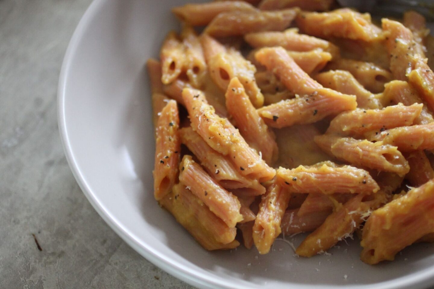 bowl of pumpkin pasta, shot from the side