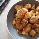 bowl of truffle maple potatoes on a dining table, shot from above