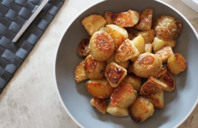 bowl of truffle maple potatoes on a dining table, shot from above
