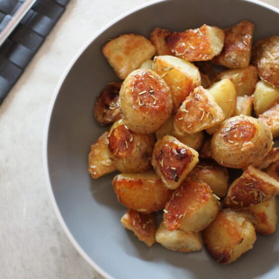 bowl of truffle maple potatoes on a dining table, shot from above