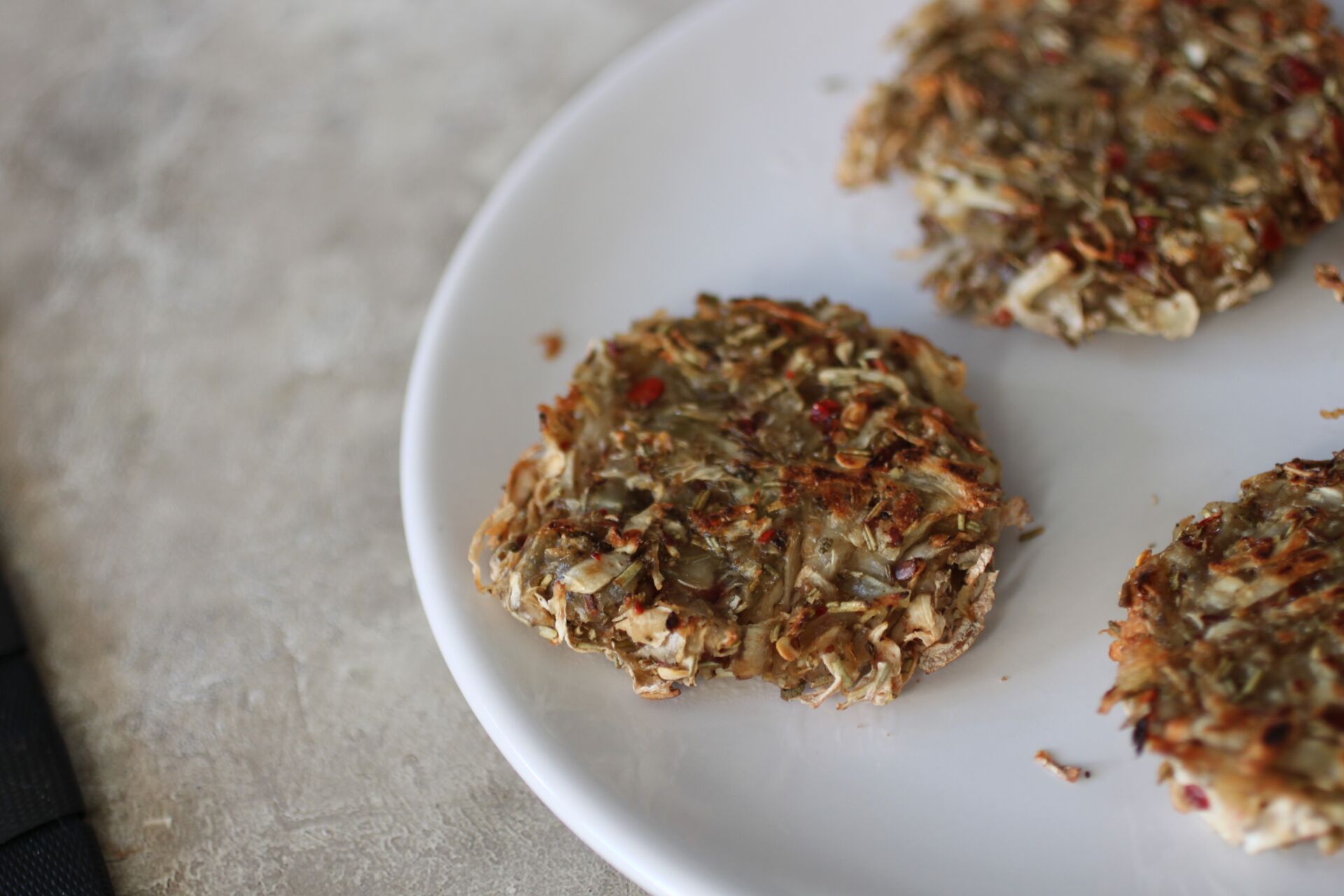 some crispy celeriac hash , baked and fried, on a white plate