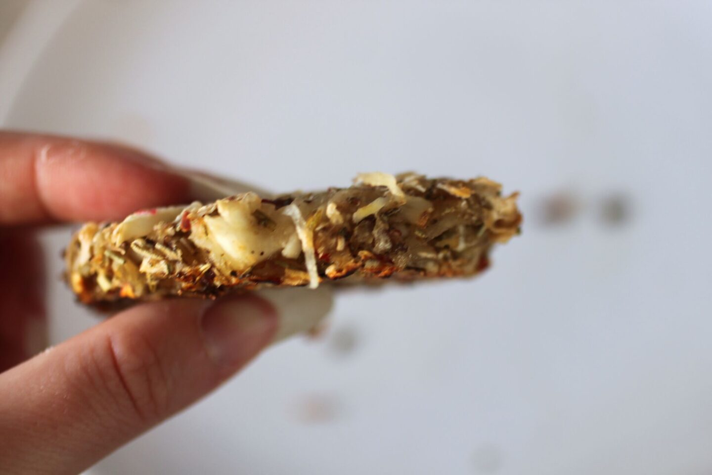 one celeriac hash held up to show texture