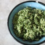 birds eye shot of a blue ceramic pot filled with kale pesto