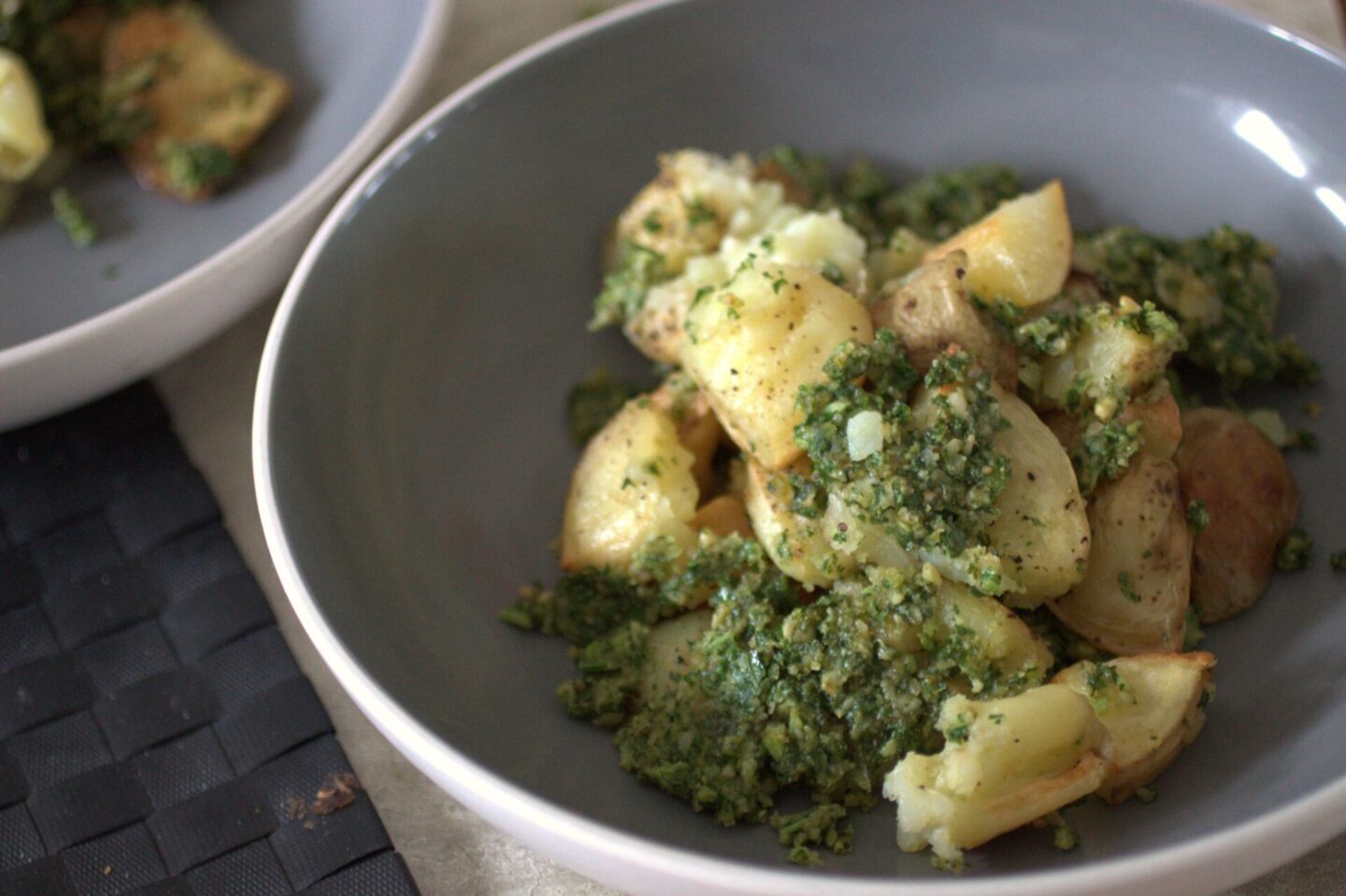 a bowl of kale pesto smashed potatoes