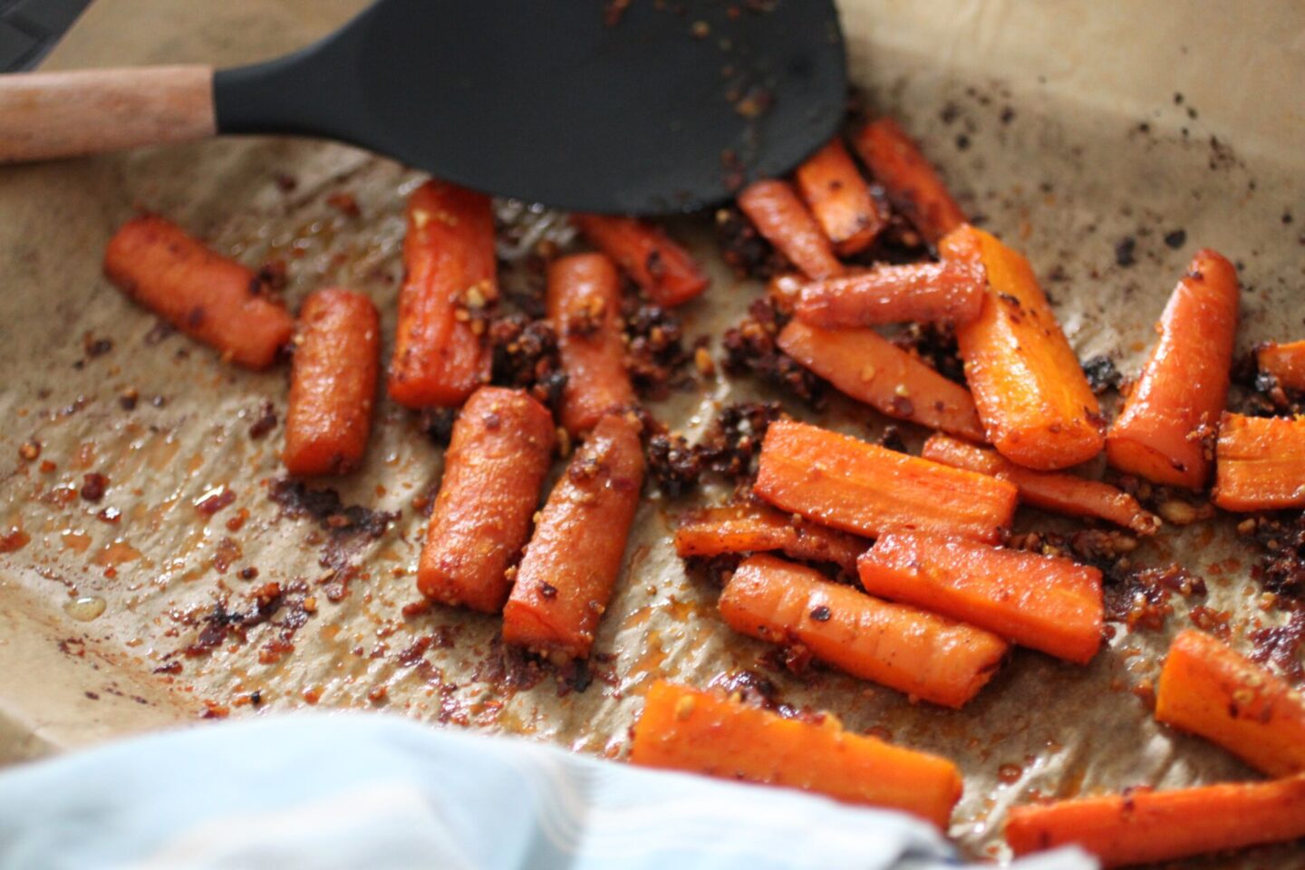 a baking tray of freshly roasted harissa parm carrots