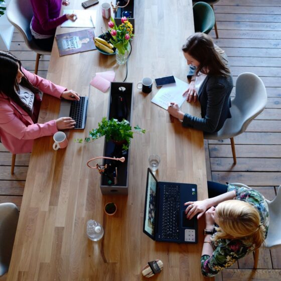 a long table with several people working
