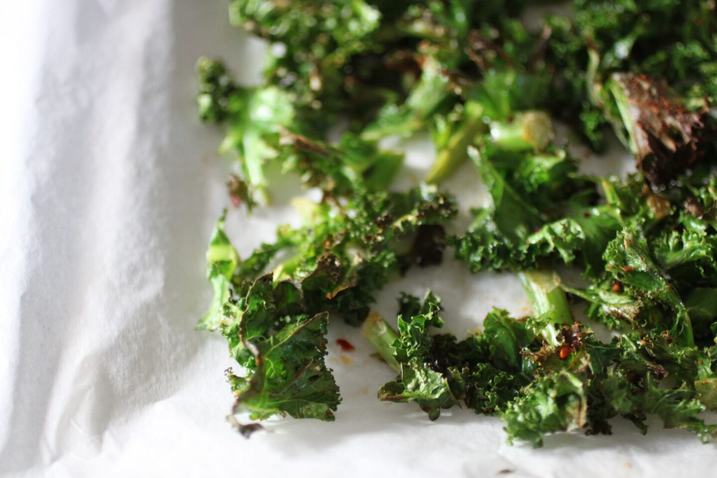 crispy kale chips close up on a baking tray