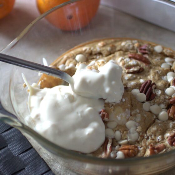 orange baked oats topped with vegan yoghurt in a dish fresh from the oven