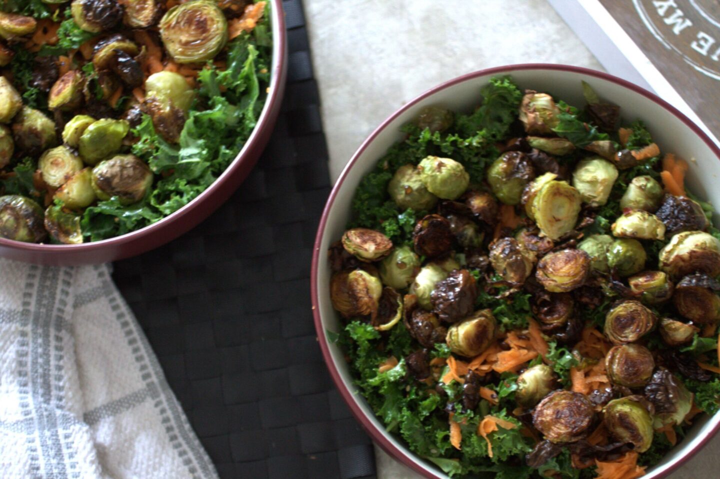 two bowls of winter vegetable salad placed on a dining table