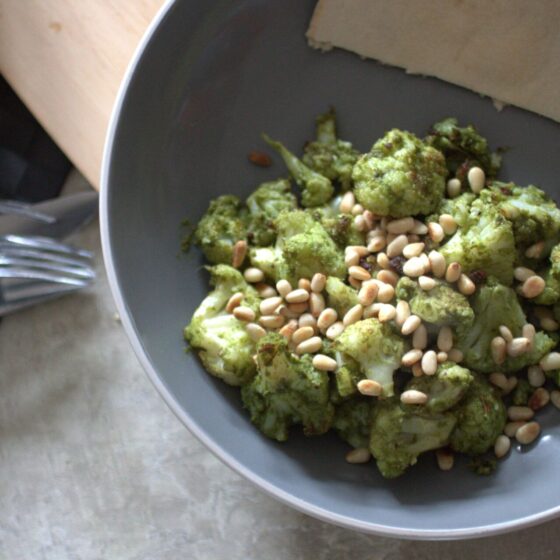 a bowl of lemon and kale baked cauliflower with a pitta bread