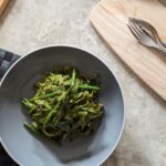 bowl of lemon asparagus fettuccine on a table, shot from above
