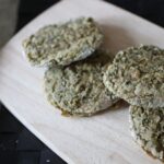 several white bean basil fritters on a wooden board