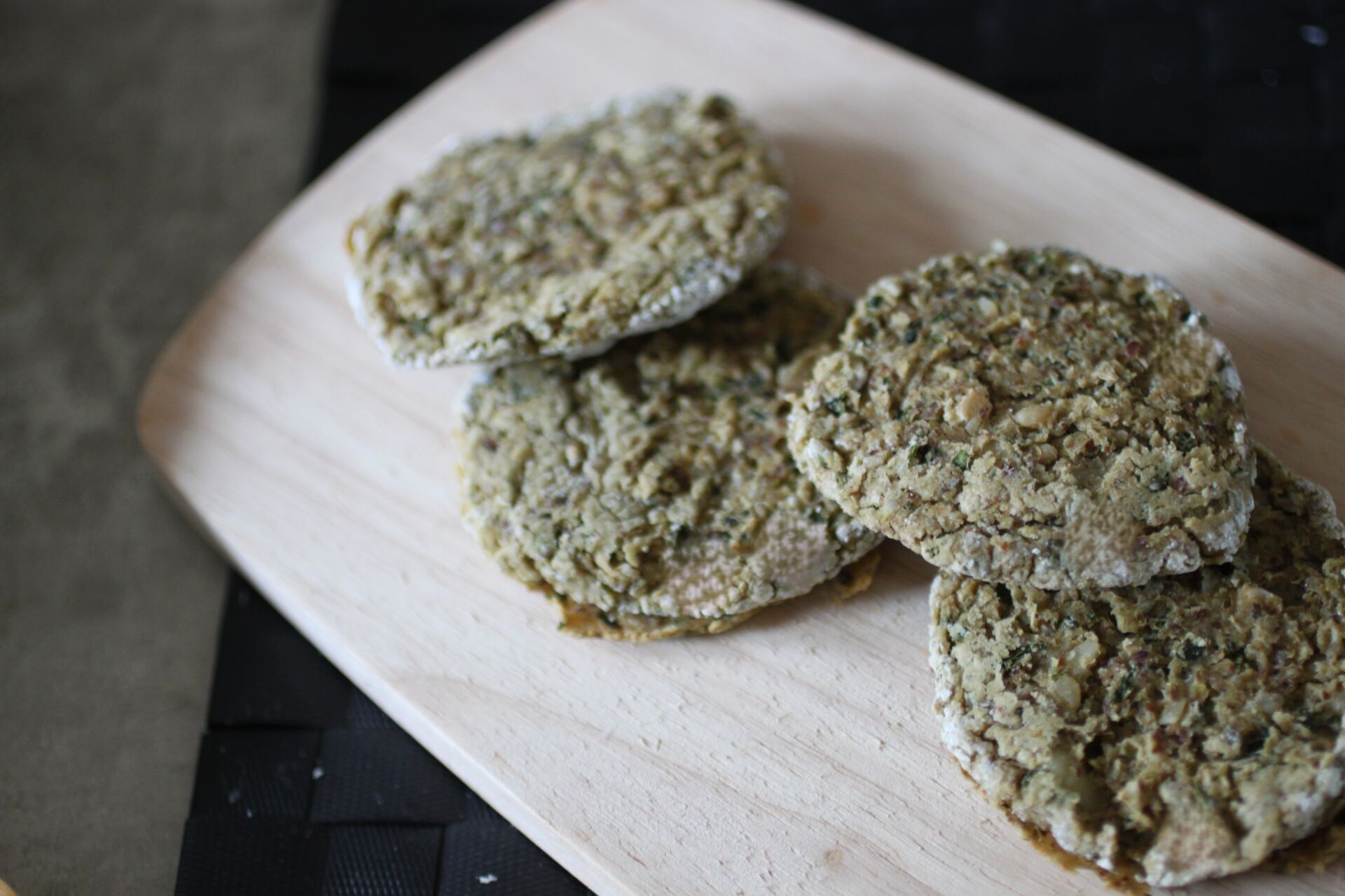 several white bean basil fritters on a wooden board