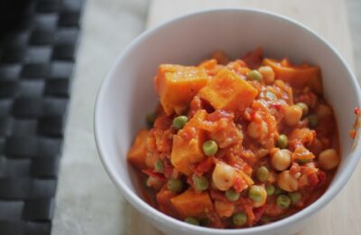 bowl of 5-a-day smokey vegetable casserole placed on a wooden board