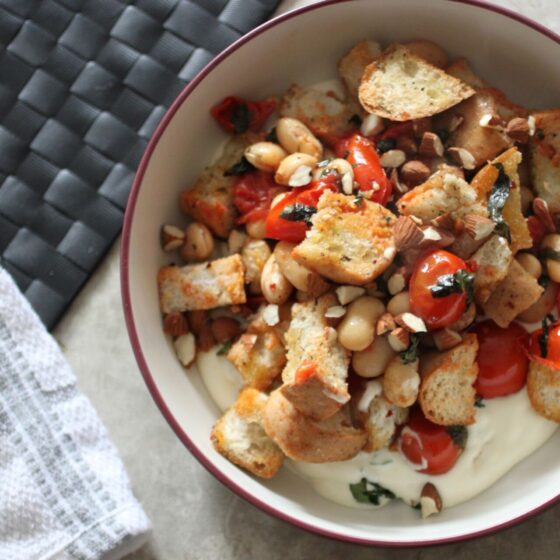 Bowl of butter bean bruschetta bake shot from above