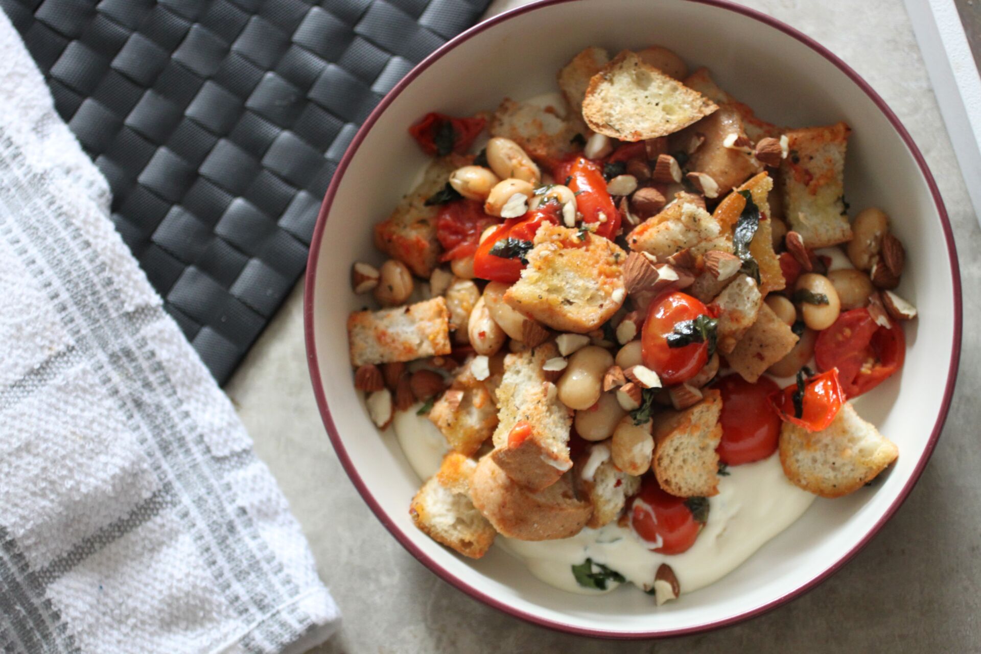 Bowl of butter bean bruschetta bake shot from above