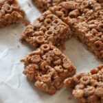sliced cereal bars on a sheet of white greaseproof paper