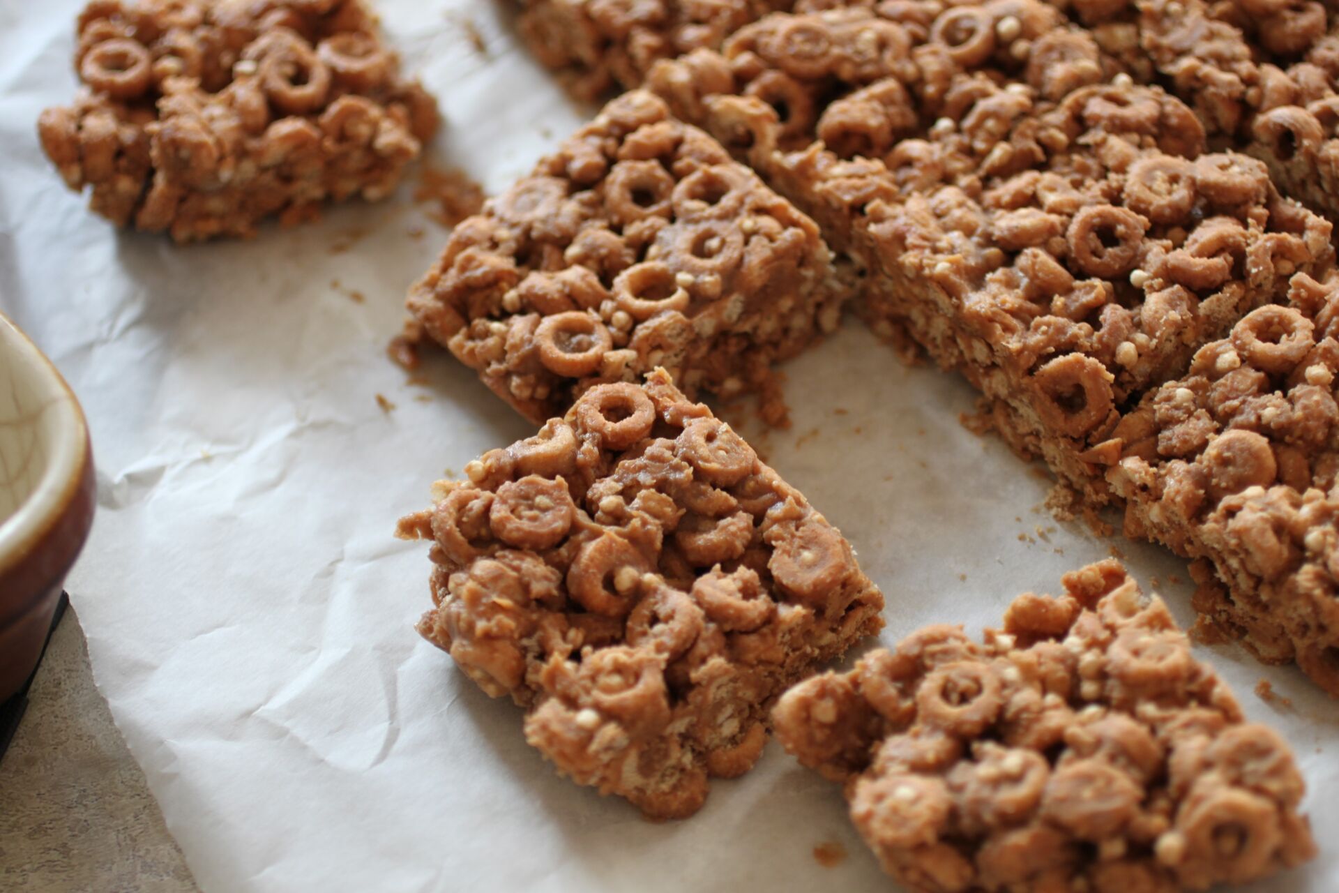 sliced cereal bars on a sheet of white greaseproof paper