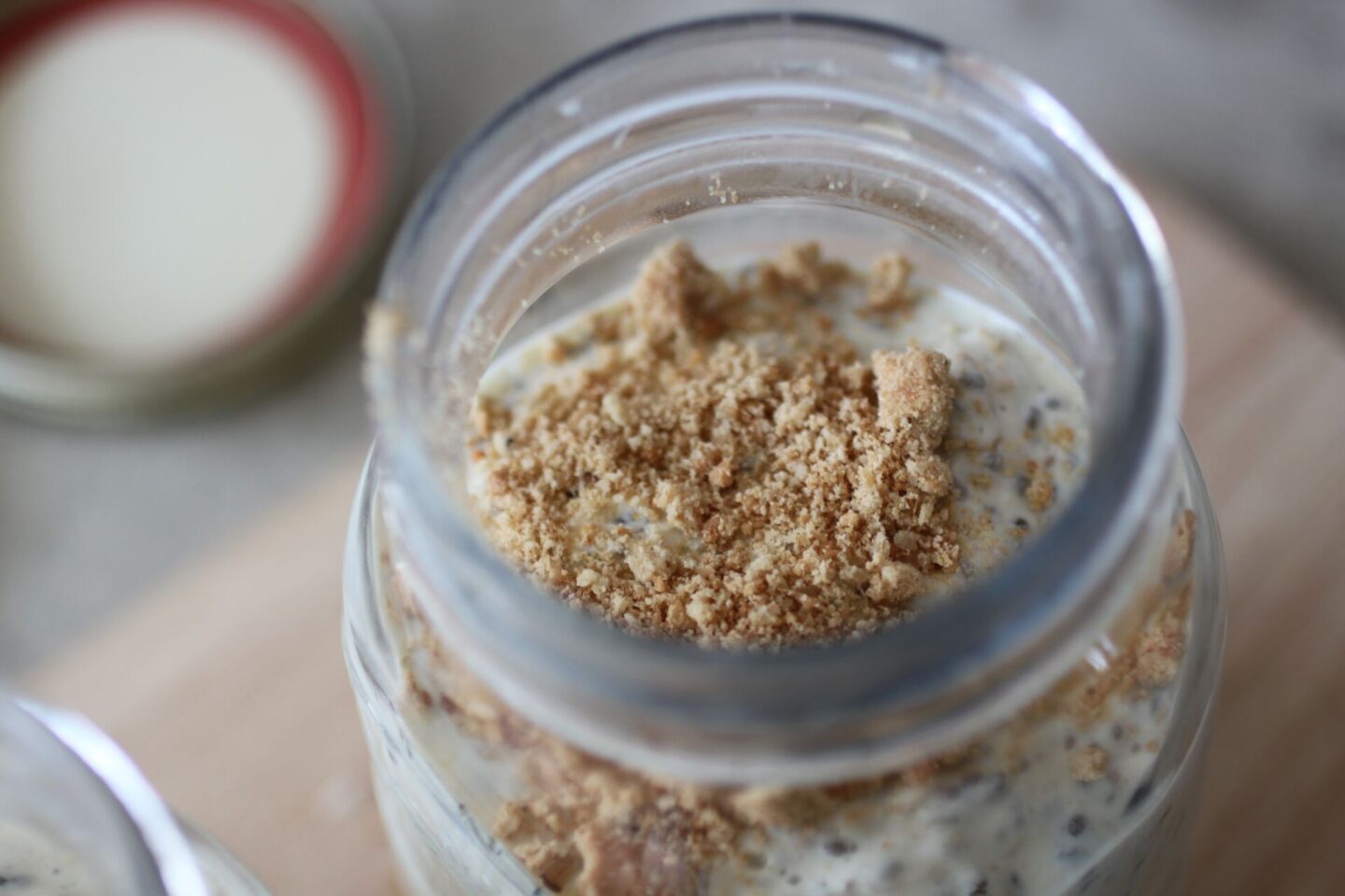 pot of key lime pie overnight oats topped with extra crumbled digestives