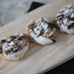 small wooden board with several peanut butter chocolate twists on it