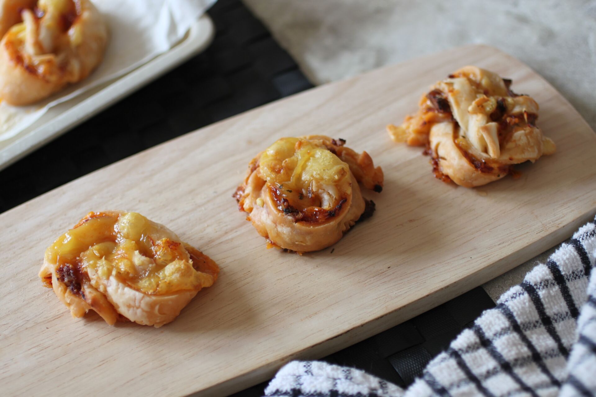 three pizza twists on a wooden tray